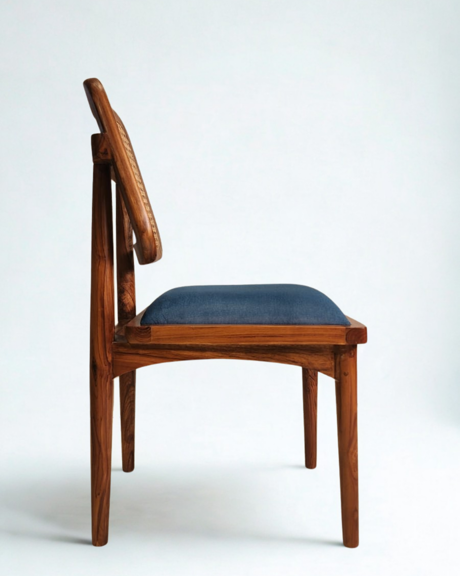 Wooden chair with a blue cushion on a white background