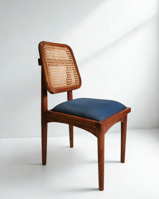 Wooden chair with wicker backrest and blue cushion on a white background